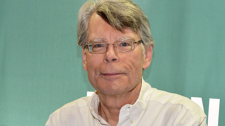 Stephen King wearing white shirt and glasses