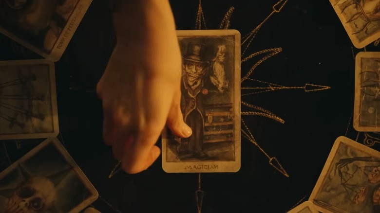 Hand laying tarot card down