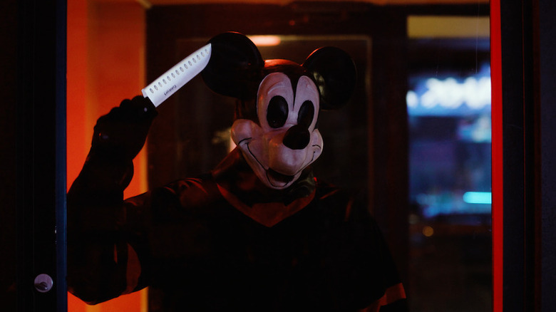 Mickey Mouse holding a knife