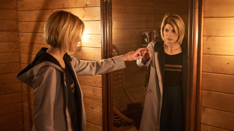 Jodie Whittaker touching mirror in Doctor Who