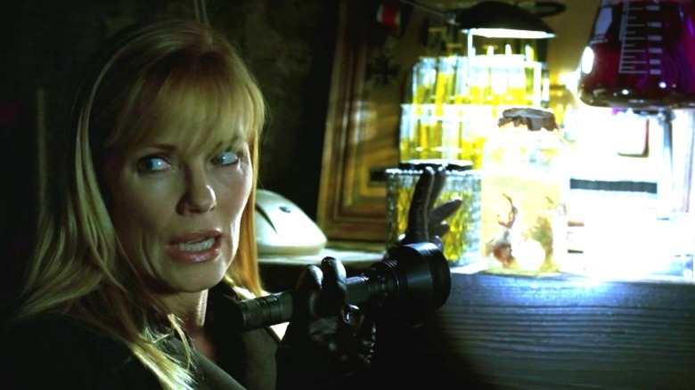 Marg Helgenberger shining light on eyeball in jar on csi