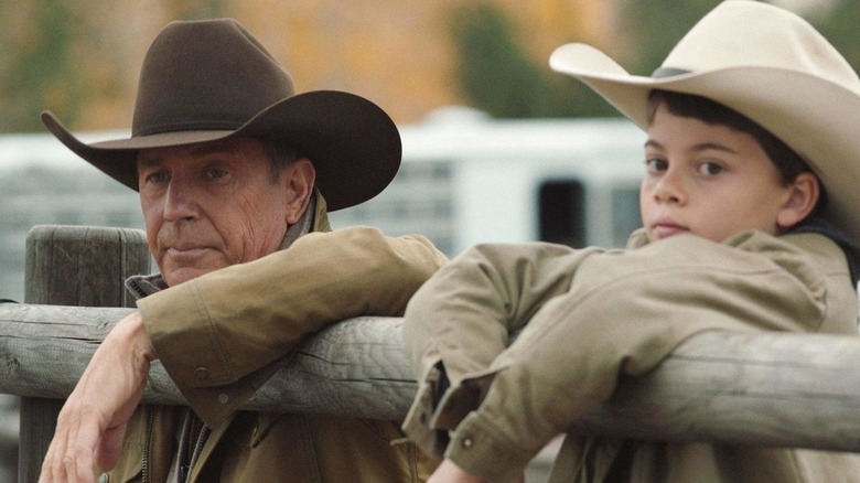 John and Tate lean on fence