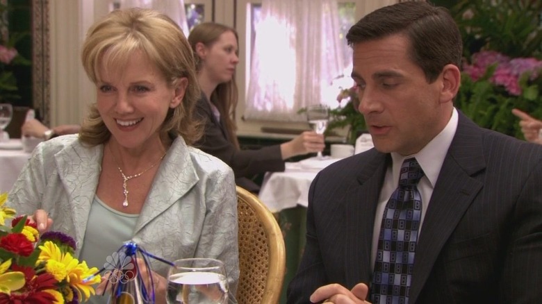 Michael Scott sitting with Helene on The Office