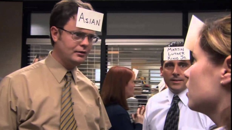 Dwight Schrute and Michael Scott with cards on heads on The Office