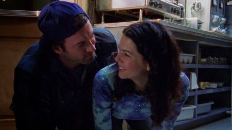 Lorelai and Luke crouching