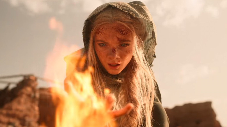 Ciri holds a flame