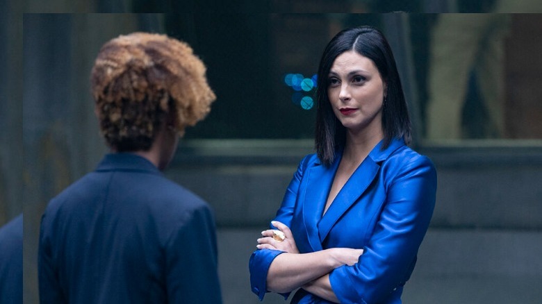 Morena Baccarin standing with arms folded