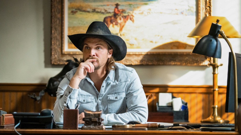 Kayce Dutton (Luke Grimes) sits in his office on Yellowstone