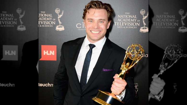 Billy Miller holding Emmy award