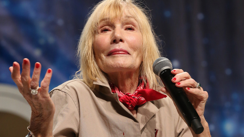 Sally Kellerman holding microphone