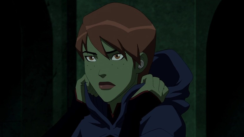 Miss Martian raising cloak hood