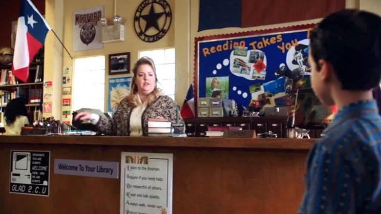 Sheryl Hutchins behind library desk