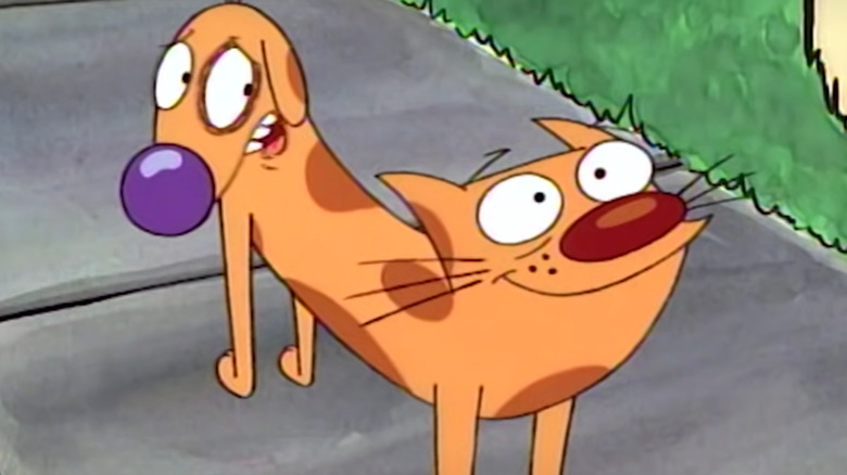 Cat looking sternly and Dog smiling in "CatDog"