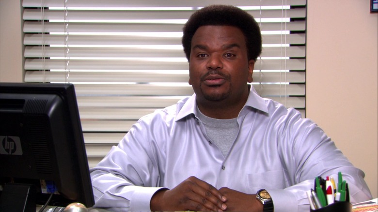 Darryl Philbin talking at his desk