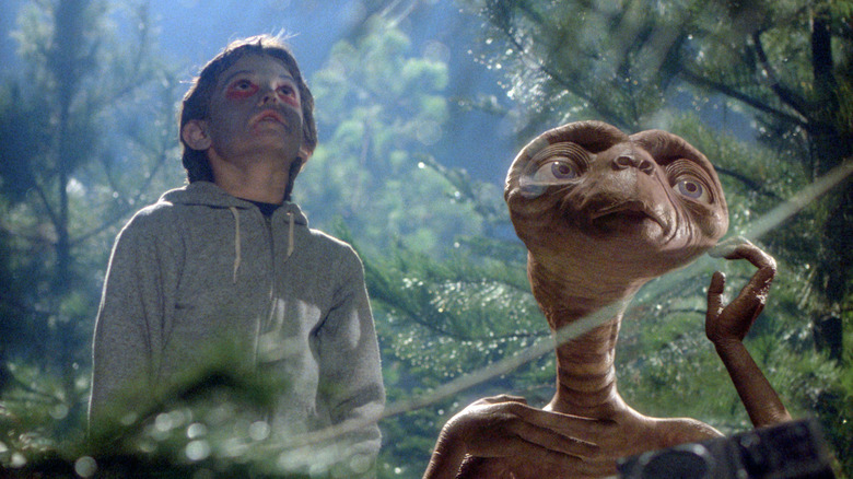 E.T. and Elliot look up towards the sky in "E.T. the Extraterrestrial" (1982)