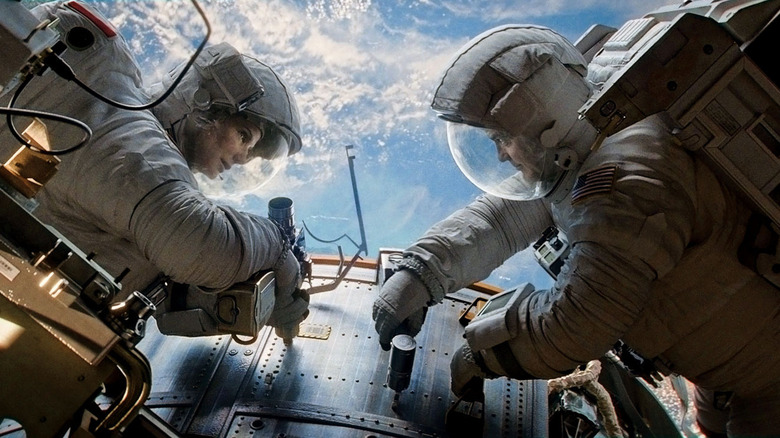 Stone and Kowalski work in space in "Gravity" (2013)