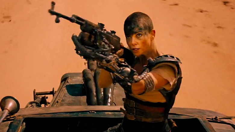 Furiosa aims a rifle in Mad Max: Fury Road