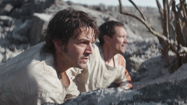 Cassian Andor and another prisoner in a barren desert