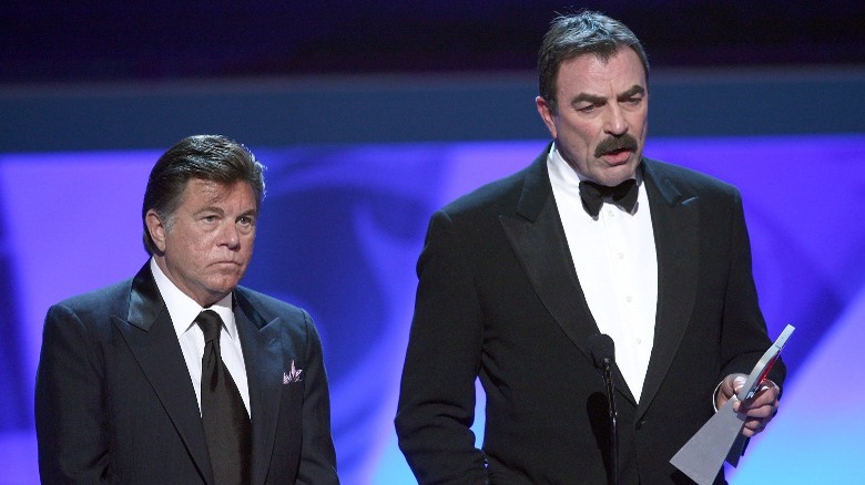 Tom Selleck and Larry Manetti talking on stage