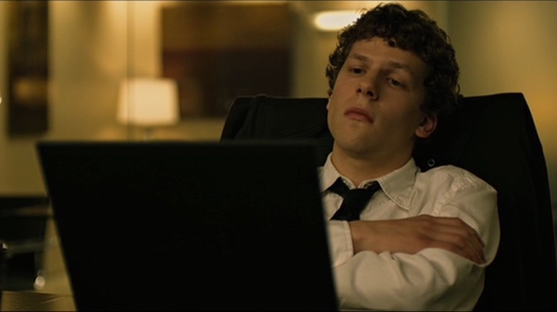 Jesse Eisenberg gazes at laptop