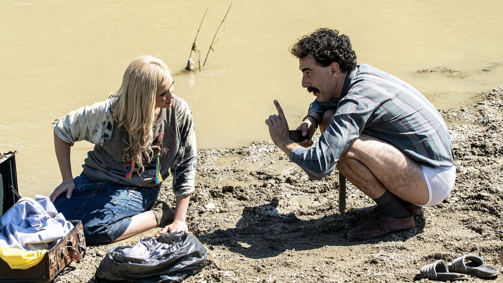 Borat and his daughter on a muddy riverbank