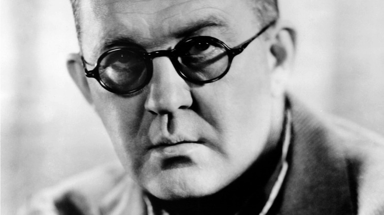 John Ford wearing glasses