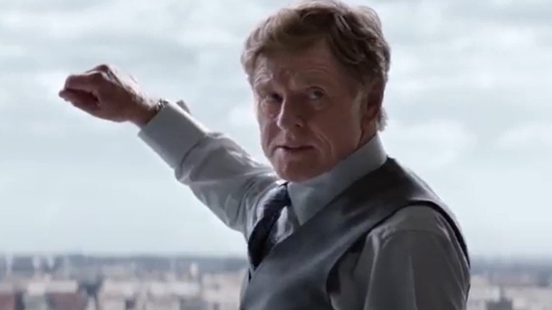 Robert Redford gestures outside