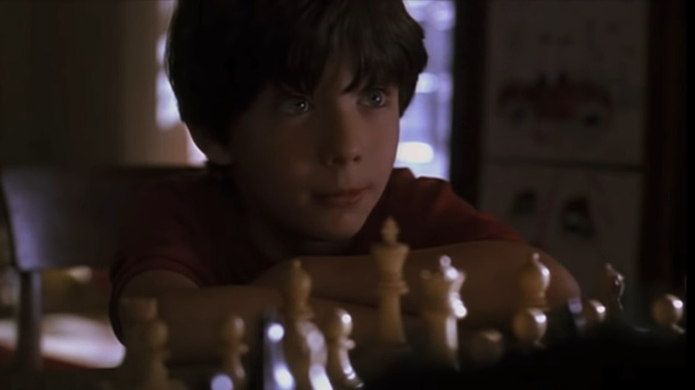 Josh in front of chess board