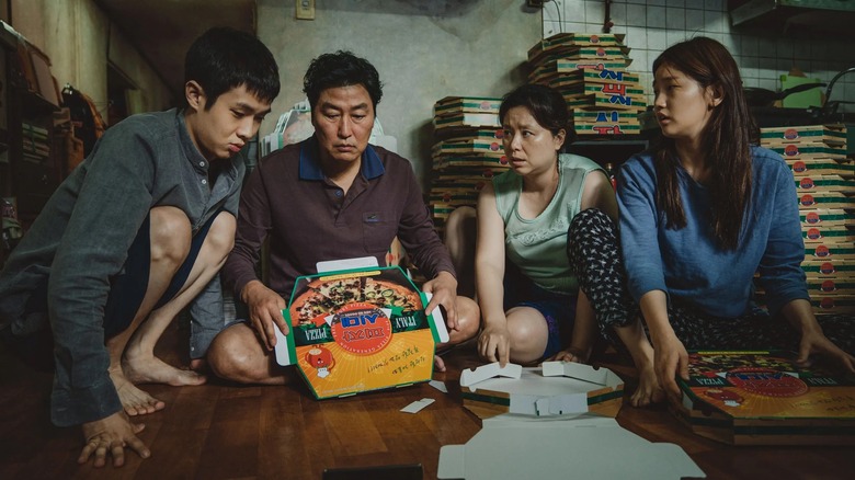 The Kim family making pizza boxes