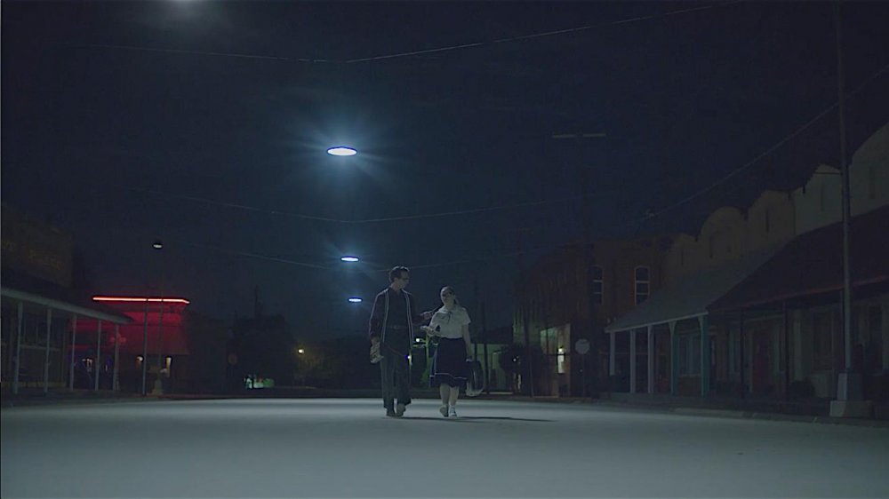 Everett and Faye walk down the street 