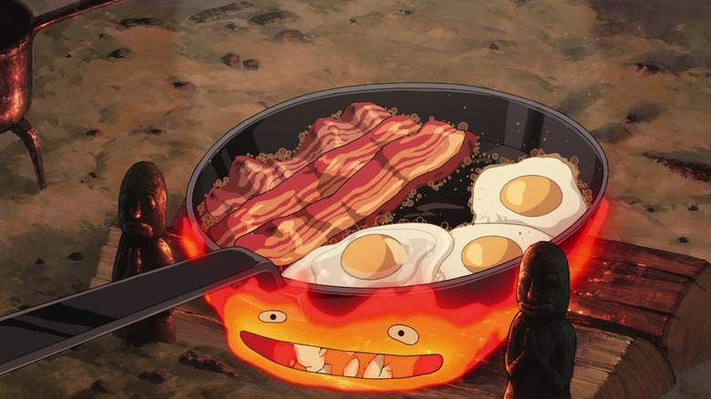 Calcifer beneath a pan of bacon and eggs in "Howl's Moving Castle"