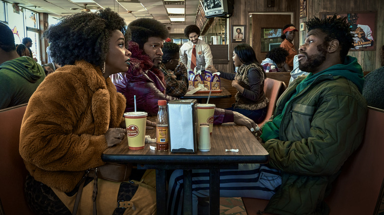 Yo-Yo, Slick Charles, and Fontaine sitting at a restaurant