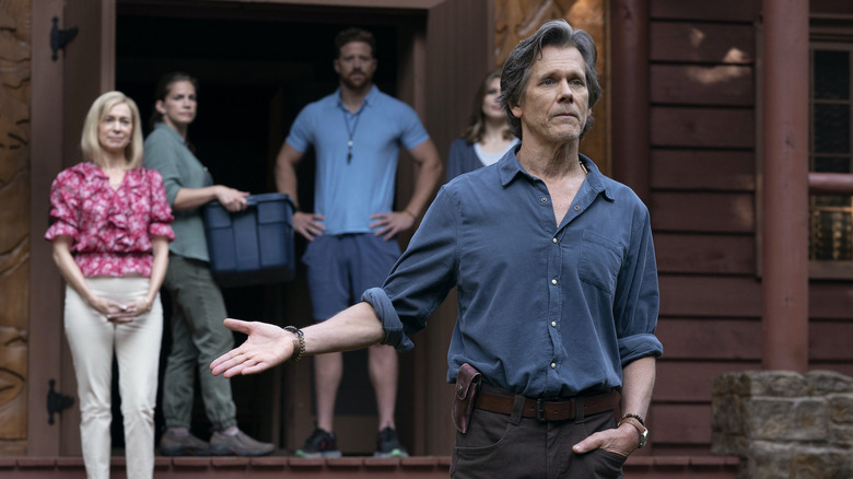 Kevin Bacon gesturing to the other counselors