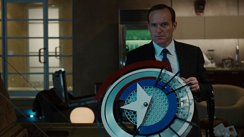 Phil Coulson holding the prototype shield