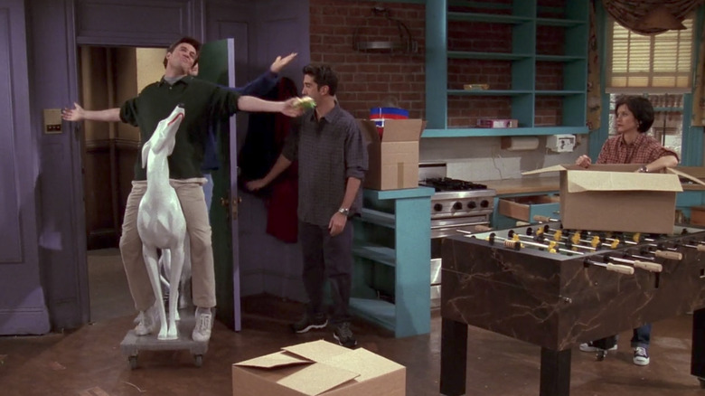 Joey and Chandler riding ceramic dog