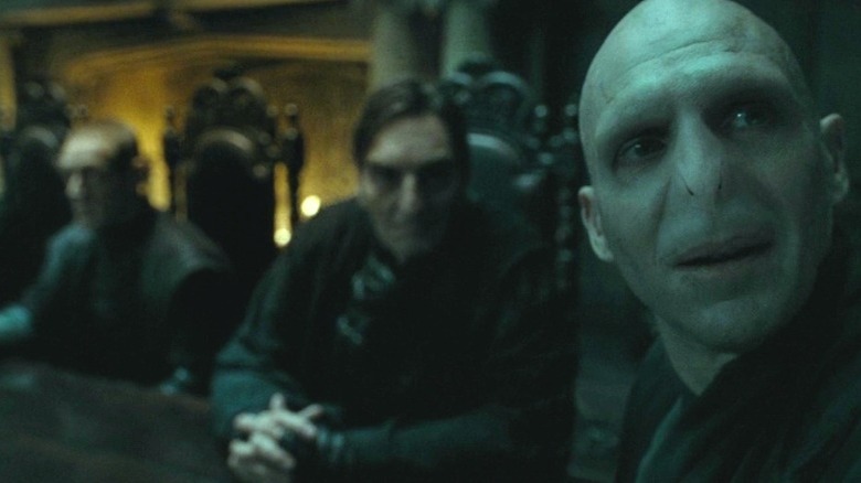 Voldemort looking away with Death Eaters