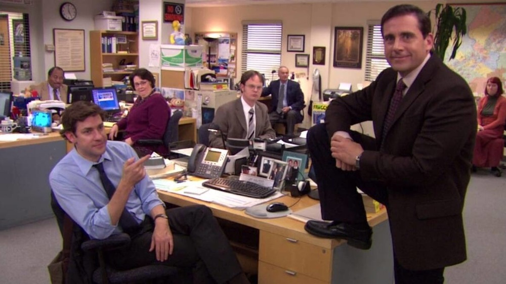 Michael Scott by Jim's desk