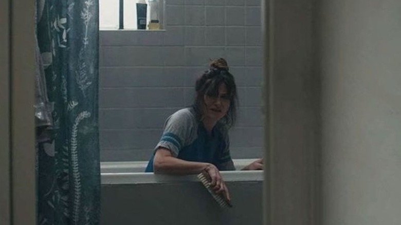 Rachel Biegler cleaning the bathtub