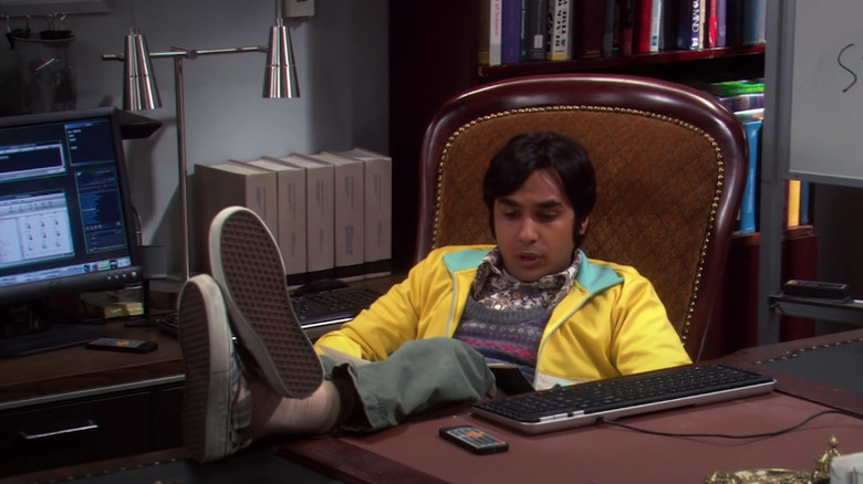 Raj sits at a desk 