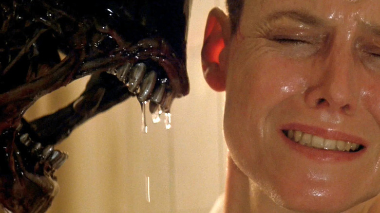 Xenomorph breathing on grimacing Ripley