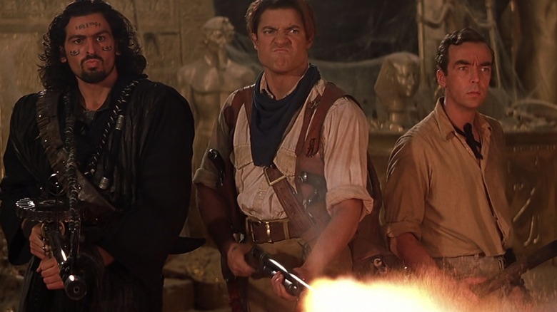 Ardeth, Rick, and Jonathan hold out weapons angrily