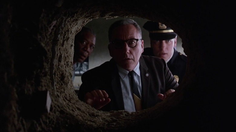 Red and guards looking through tunnel