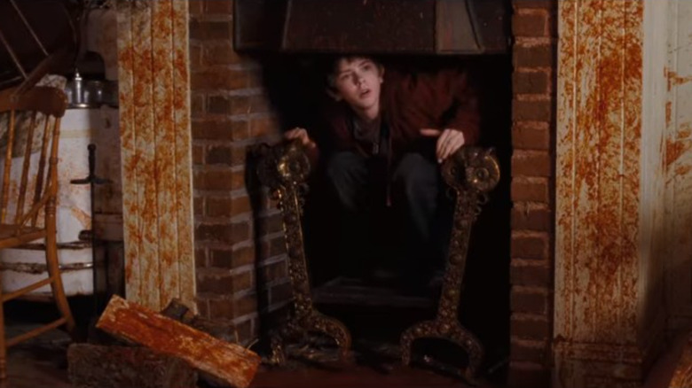 Jared Grace emerges from a fireplace