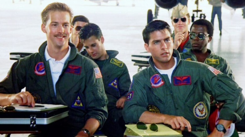 Goose and Maverick sit at briefing