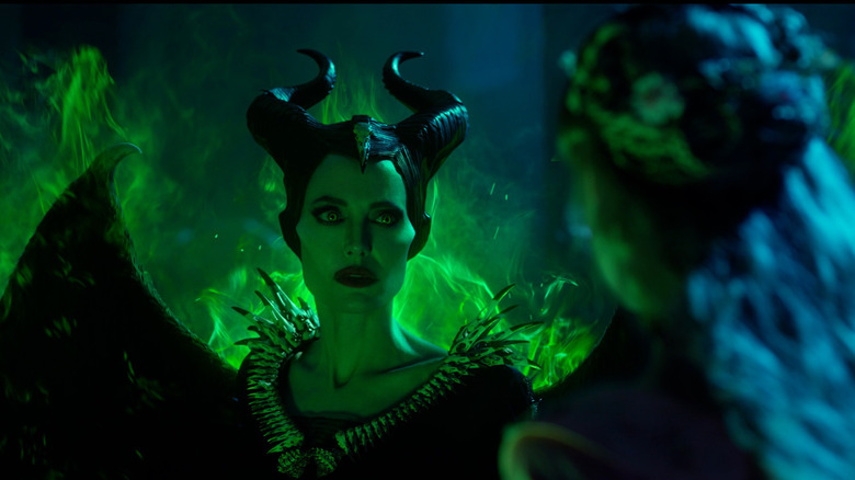 Angelina Jolie as Maleficent, wreathed in green flames