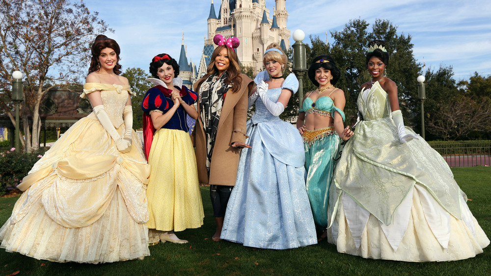 Wendy Williams poses with Belle, Snow White, Cinderella, Jasmine, and Tiana in Walt Disney World