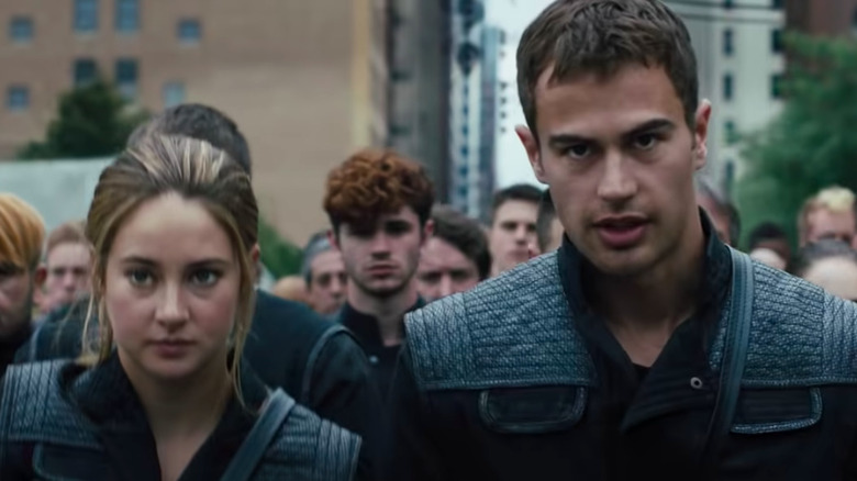 Tris and Four in military gear with a group of Dauntless