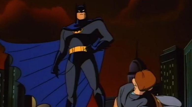 Batman stands above a criminal tied up