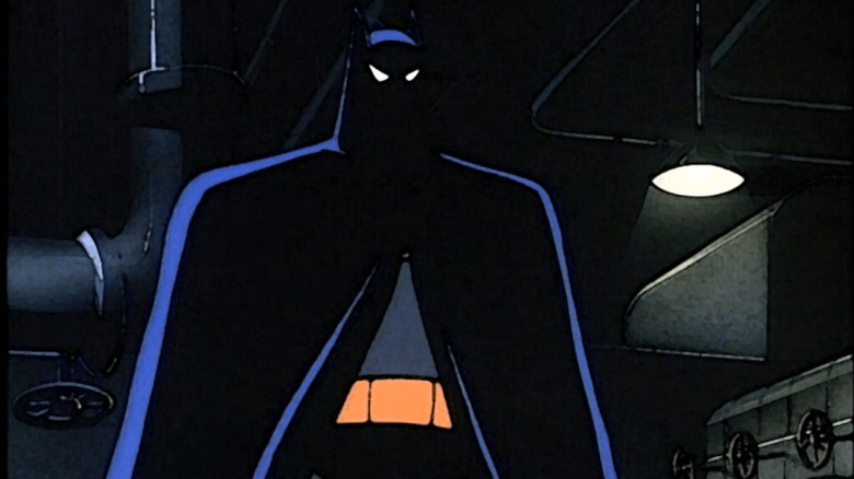 Batman stands in the shadows