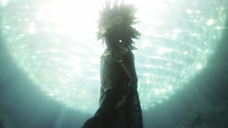 Namor wears crown underwater next to bright light